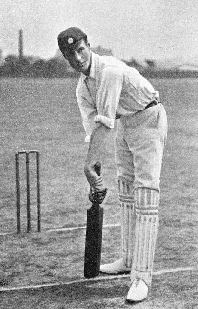 Francis Lacey in a posed photograph holding a bat